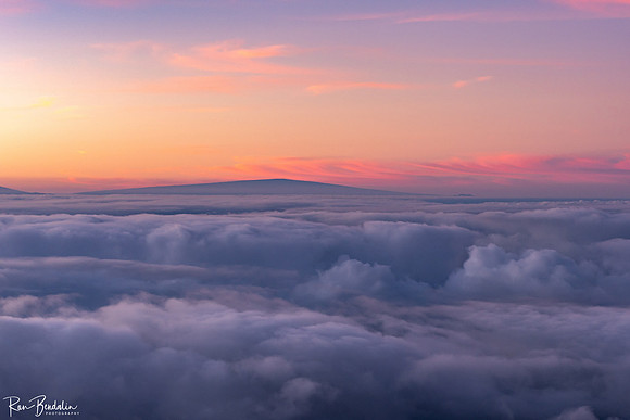 Cotton candy clouds above Mauna Loa, seen from peak of Haleakala